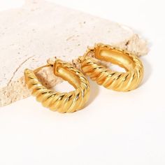 Elevate your outfit with the timeless style of the Carrie Hoops. These twisted gold hoop earrings, made from luxurious materials, offer a beautiful blend of elegance and sophistication. Their classic silhouette will offer a touch of sophistication to any look. Experience the beauty and prestige of the Carrie Hoops. Size: 1 Inch Materials: Stainless Steel Gold Plating Water & Tarnish Resistant Traditional Earrings, Stainless Steel Plate, Steel Earrings, Stainless Steel Earrings, Hight Quality, Gold Hoops, Gold Plated Earrings, Perfect Gift For Her, Gold Hoop Earrings