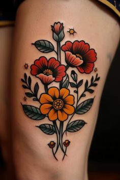 a woman's thigh with flowers and leaves on it