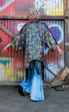 In collaboration with the Grateful Dead, Jammin Warrior Collective brings you the perfect Kimono for all your adventures. Perfect over accessory for beach or festival Adorned with 8 inch knotted black fringe Bright + Light in weight and print Fabric Features: Soft Crush Velvet printed in our studio in Sonoma County, CA. Polyester fabric, polyester fringe is dry clean only. Fit: One Size Warrior Within, The Grateful Dead, Velvet Kimono, Dancing Bears, Sonoma County, Black Fringe, Grateful Dead, Bright Light, Crushed Velvet