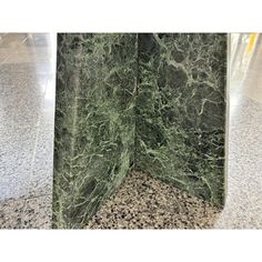 the corner of a green marble display case