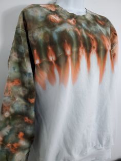 a white and orange tie dye shirt on a mannequin head