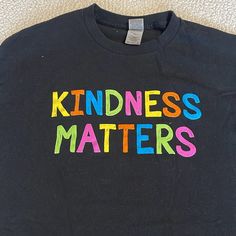 Gilden T-Shirt With Kindness Matters On The Front. Short Sleeves. Never Worn. Smoke Free/Pet Free Home. Fun Black Shirt With Letter Print, Fun Black Pre-shrunk T-shirt, Fun Black Tops With Text Print, Fun Black Top With Text Print, Fun Black T-shirt, Black Relaxed Fit Fun T-shirt, Fun Black Relaxed Fit T-shirt, Fun Black Tops With Screen Print, Fun Black Slogan Top