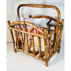 a bamboo magazine rack with magazines in it