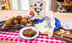 a table topped with plates of food and condiments