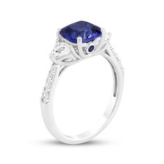 This glimmering blue lab-created sapphire ring makes an unforgettable gift for your special occasion. Sterling silver A cushion-cut blue lab-created sapphire is flanked by trillion-cut white lab-created sapphires Bezel-set round blue lab-created sapphires shimmer on the sides of the setting Round-cut white lab-created sapphires line the tapered shank Blue Radiant Cut Lab-created Sapphire Jewelry, Lab-created Sapphire Diamond Ring In Cushion Cut, Lab-created Sapphire Diamond Ring With Cushion Cut, Cushion Cut Diamond Ring With Center Stone Lab-created Sapphire, Cushion-cut Tanzanite Jewelry For Anniversary, Cushion Cut Sapphire Ring With Cubic Zirconia Accent Stones, Sapphire Jewelry With Cushion Cut Center Stone, Cushion Cut Tanzanite Jewelry For Anniversary, Sapphire Cushion Cut Jewelry With Center Stone