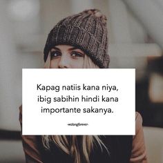 a woman wearing a beanie and holding a sign with the words kapag nattis kana niya, i dig sabih hinhn hindi