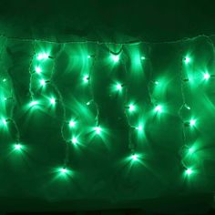 green christmas lights are hanging on the wall