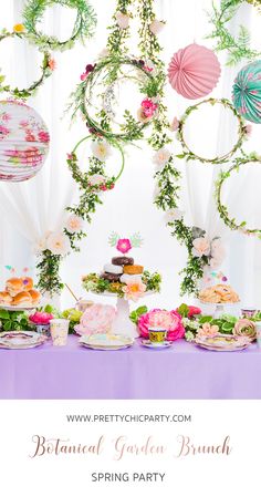 an elegant garden brunch spring party with flowers and greenery on the table