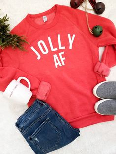 Are you Jolly AF for the holidays... well then this sweatshirt has your name all over it 50/46/4 polyester (6.25% recycled)/cotton (6.25% organic)/rayon, 30 singles Slim fit Low-impact dyed and washed Raglan sleeves Wash on Cold Inside out to preserve the life of the garment Casual Festive Sweatshirt For Fall, Casual Fall Festive Sweatshirt, Casual Christmas Sweatshirt For Festive Occasion, Casual Christmas Festive Sweatshirt, Casual Christmas Sweatshirt, Casual Christmas Sweater With Relaxed Fit, Casual Christmas Sweatshirt With Letter Print, Casual Christmas Sweater For Loungewear, Red Casual Holiday Sweatshirt