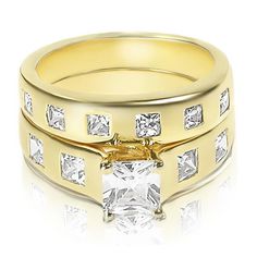 two gold wedding rings with princess cut diamonds on the sides and a square diamond in the middle