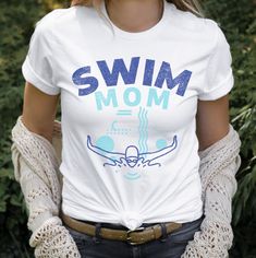 a woman wearing a white shirt with the words swim mom on it