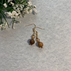 Already Made, ready to ship. Fish hook earring closure on a pendent with 2 rounded Orange and Brown beads as well as gold accent beads. Everything is beads, there are no precious metals. Cheap Brown Dangling Beads Earrings, Gold Beaded Round Earrings, Gold Beaded Round Earrings As Gift, Round Gold Beads Earrings For Gift, Gold Beaded Earrings Gift, Gold Beaded Earrings For Gift, Gold Beaded Round Earrings For Gift, Gift Gold Beaded Earrings, Adjustable Gold Beaded Dangle Earrings