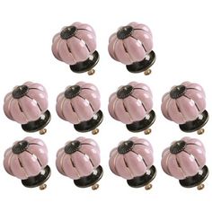 twelve pink glass knobs with black accents on each one and the other side are shown