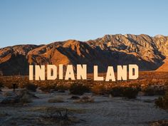 a large-scale installation in the desert resembling the Hollywood sign that reads "INDIAN LAND" Indigenous Knowledge, Interactive Installation, Coachella Valley, Palm Desert, Indigenous Community, Spring Art, Wakefield, International Artist, Desert Landscaping