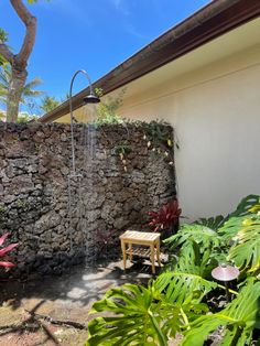 an outdoor shower in the middle of a garden