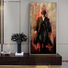 a painting on a wall next to a vase with a plant in it and a man wearing a top hat