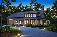 a large house with lots of windows and lights on the front door is lit up at night