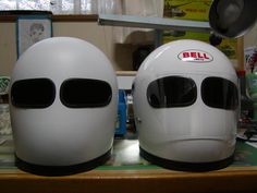 two white helmets sitting on top of a table