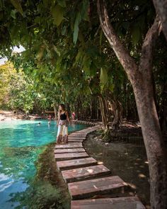 a woman standing on the edge of a pool