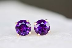 "Lovely genuine AAA grade amethyst is set in 14k gold. Lightweight and gorgeous, these are a great gift for anyone on your list. Perfect for everyday wear or for those who like to make a dainty minimalist statement. Size : 6mm Metal : 18kt Gold Gemstones : 1.75 cts AAA Amethyst \"Amethyst ranges in colour from violet to dark purple. Amethyst is one of relatively few gemstones with the specific purpose of improving intellectual and cerebral thought. Amethyst crystals are also known for their rule Purple Birthstone Earrings For Formal Occasions, Formal Purple Birthstone Earrings, Purple 14k Gold Earrings With Prong Setting, 14k Gold Purple Earrings With Prong Setting, Amethyst Studs, Amethyst Crystals, Pearl And Diamond Earrings, Birthstone Earrings, Graduation Gifts For Her