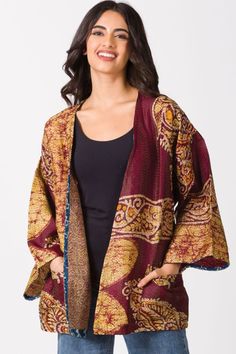 Our Silk Kantha Kimono Jacket is handmade by women artisans in India using 100% silk up-cycled saris. Each piece is uniquely beautiful and features exquisite hand stitching known as “kantha” that is done by women artisans in West Bengal, India, with indigo block print trim detail. Designed in a contemporary, elegant cut with different sari prints on each side and pockets, these handmade kimonos are reversible and each piece is truly a wearable work of art. 

One size fits most, comes in assorted Indigo Block Print, Sari Scarf, Kantha Sari, Kantha Silk, High Neck Crop Top, Fair Trade Clothing, Kantha Throw, Cotton Scarf, Kimono Jacket