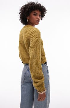 Fuzzy texture is punctuated with cables in a cropped cardigan designed with a slouchy fit. 18" length (size Medium) Front button closure Crewneck Long sleeves Dropped shoulders Ribbed cuffs and hem 47% polyester, 37% nylon, 11% acrylic, 5% wool, Machine wash, dry flat Imported Casual Cropped Cardigan With Pointelle Knit, Cropped Open Knit Cardigan, Fall Open Knit Cropped Sweater, Cropped Textured Knit Sweater For Layering, Winter Cropped Pointelle Knit Cardigan, Cropped Pointelle Knit Cardigan For Winter, Cropped Pointelle Knit Cardigan For Fall, Cropped Open Knit Sweater For Layering, Fall Cropped Open Knit Cardigan