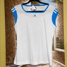 This Is A Truly Pretty T-Shirt! Bright White With The Pretty Adidas Blue Combo. The Logo In The Front Is Raised. The Detail On The Back Is Hot!!! Climacool’s Unique Features With Keep You Dry And Cool, While Looking Ultra Stylish In This Beautiful Top! Size Is L. Summer Tennis Tops With Short Sleeves, Short Sleeve Tennis Tops For Summer, Short Sleeve Summer Tennis Tops, Summer Short Sleeve Tennis Tops, Blue Sporty Tops For Tennis, Sporty Blue Tennis Tops, Moisture-wicking Tennis Tops For Summer, Blue Short Sleeve Tennis Top, Blue Casual Tennis Top