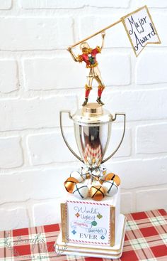 a trophy sitting on top of a table next to a red and white checkered table cloth