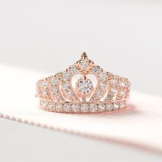 This tiara Ring is carefully crafted with fine details. This sophisticated design is characterized with a crown measures about 12mm tall, a 3.5mm centerstone and plenty of small brilliant stones. We made our ring with the highest quality of cz stone that is accessible to us, they sparkles Rose Gold Ring With Crown Design, Rose Gold Crown Design Promise Ring, Cubic Zirconia Diamond Ring With Crown Design, Formal Rose Gold Jewelry With Crown Design, Crown Shaped Jewelry For Anniversary, Gift Crown Design Diamond Ring, Elegant Round Crown For Gift, Elegant Rings With Crown Design, Elegant Wedding Rings With Round Crown