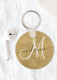 a personalized metal keychain with the word, name and initial on it