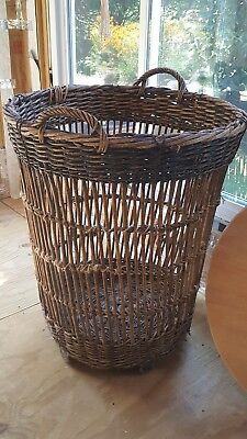 a brown wicker basket sitting on top of a wooden floor