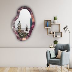 a living room with a chair, mirror and shelf on the wall next to it