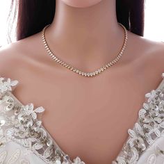 a woman wearing a necklace with pearls on it