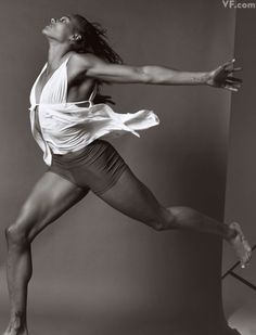 a black and white photo of a woman dancing