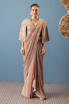 Sand drift pre-draped saree with sequin embroidered border. Paired with a cape sleeve blouse with floral, sequins, pearl embroidery. - Aza Fashions Silk Traditional Wear For Eid With Draped Design, Silk Draped Traditional Wear For Eid, Draped Silk Traditional Wear For Eid, Eid Blouse Piece With Draped Pallu, Eid Draped Pallu Blouse Piece, Eid Draped Blouse Piece With Pallu, Eid Special Zari Work Pre-draped Saree, Draped Traditional Wear For Diwali, Draped Saree