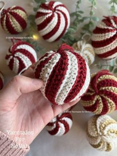 a hand is holding an ornament made from yarn