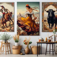 three paintings are hanging on the wall above a table