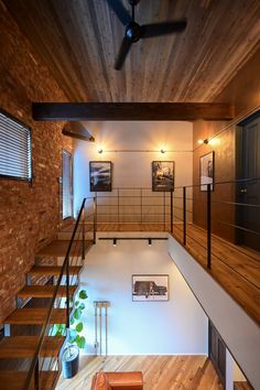 a living room filled with furniture next to a wooden floor and ceiling mounted air conditioner