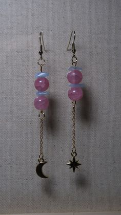 These dangling earrings are made up of pink beads, blue rock beads, a moon and star charm and golden details. Pink Star Charm Dangle Earrings, Pink Dangle Earrings With Star Charm, Wire Charms, Bead Things, Earring Inspo, Blue Rock, Earrings Ideas, Diy Jewelry Unique, Moon And Star Earrings