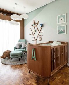 a baby's room with a crib, rocking chair and pictures on the wall