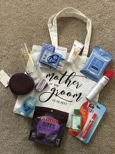 a mother of the groom tote bag with its contents laid out on the floor