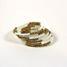 Beaded memory wire bracelet; white and gold beaded bracelet White Wedding Bracelets With Gold Beads, Adjustable White Hand Wrapped Beaded Bracelets, White Stretch Bracelet With Gold Beads As Gift, Adjustable Beaded White Wrap Bracelet, Adjustable White Beaded Wrap Bracelet, White Gold Beads Bracelet, White Tiny Beads Bracelet For Wedding, White Tiny Beads Bracelets For Wedding, White Hand Wrapped Round Beads Stretch Bracelet