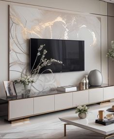 a living room scene with focus on the entertainment center and large screen television mounted to the wall