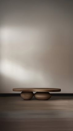 two round wooden tables sitting on top of each other in front of a gray wall