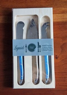 two forks and spoons in a box on a table