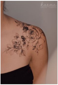 a woman wearing a black dress with flowers on her chest and shoulder tattoo design in the center