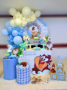 a birthday cake with balloons and animals on it