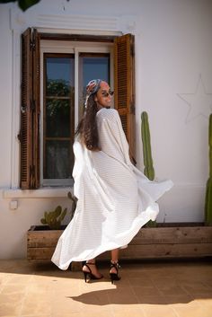 Handmade black and white stripes kaftan, designed with handmade silk pompoms. very loose and flattering to any body type.pair it with heels or flats. Must have style in any wardrobe.DETAILSViscose, linenFront Handmade Silk pompomOne size fits allThis is a very loose kaftan. The model wears SmallDry clean onlyHandmade in Morocco.Got a question!! don't hesitate to contact me :) Striped Long Sleeve Maxi Dress For Vacation, Striped Maxi Dress For Beach Cover-up, Striped Kaftan For Summer Beach Cover-up, Striped Long Maxi Dress For Summer, Chic White Flowy Kaftan, Striped Bohemian Maxi Dress For Summer, Bohemian Striped Maxi Dress For Summer, Oversized Striped Summer Dresses, Bohemian Striped Dresses For Day Out