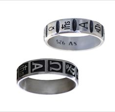 two silver rings with roman numerals and numbers on the sides, one in black