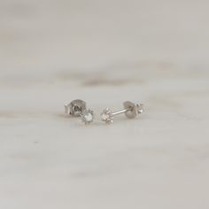 Such a cute, and dainty pair of earrings! They're perfect alone or stacked. They're a tiny pair that are perfect for second piercings, cartilage piercings, or for a minimalist touch. ✤✤ Details ✤✤ ☼ Made of 925 Sterling Silver ☾ We use a THICK plating of 14k Gold or Rhodium for a piece that is sure to last you years to come ★ Sold as a PAIR ☼ Nickel-free & Hypoallergenic ★ Measures 3.5 mm x 3.5 mm ☾ We use the highest grade of cubic zirconia for an authentic diamond look Comes in a cute gift Second Piercings, Tiny Gold Studs, Huggie Earrings Gold, Cartilage Piercings, Small Gold Hoop Earrings, Opal Stud Earrings, Sun Earrings, Small Stud Earrings, Minimalist Earrings Studs